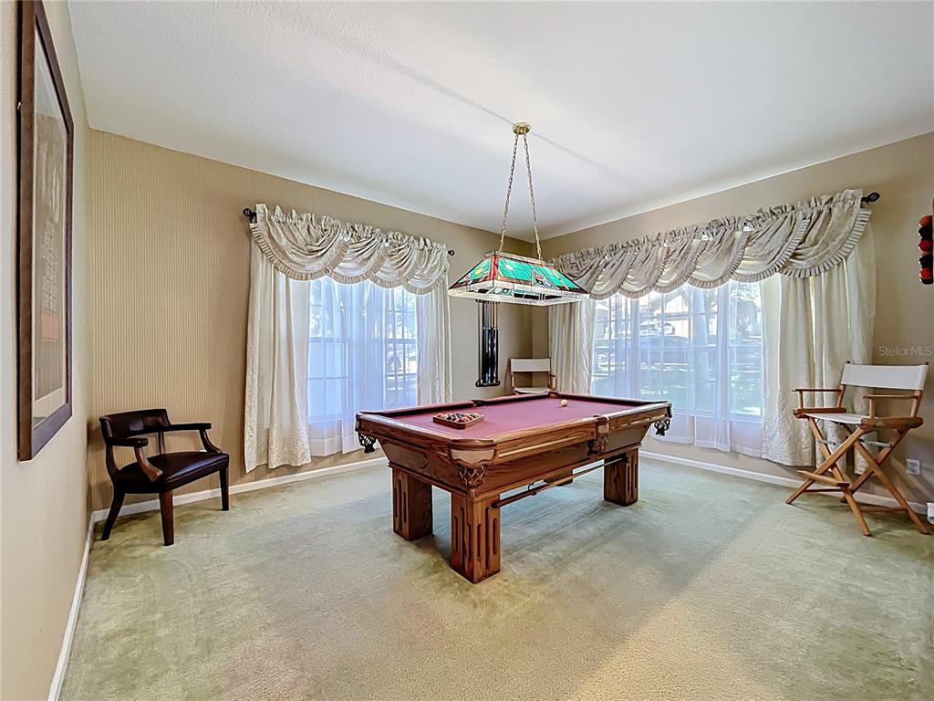 13319 Via Roma Circle Clermont, FL 34711 - Photo 14 of 44 a room with pool table and a chandelier