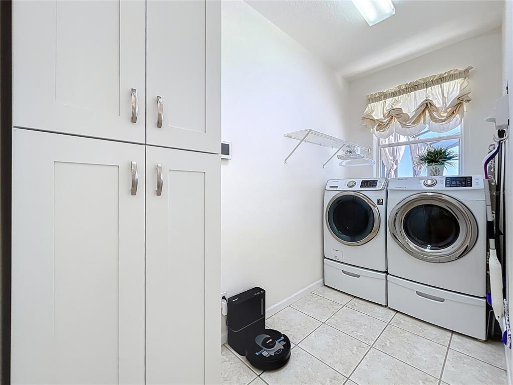 13319 Via Roma Circle Clermont, FL 34711 - Photo 23 of 44 a utility room with dryer and washer