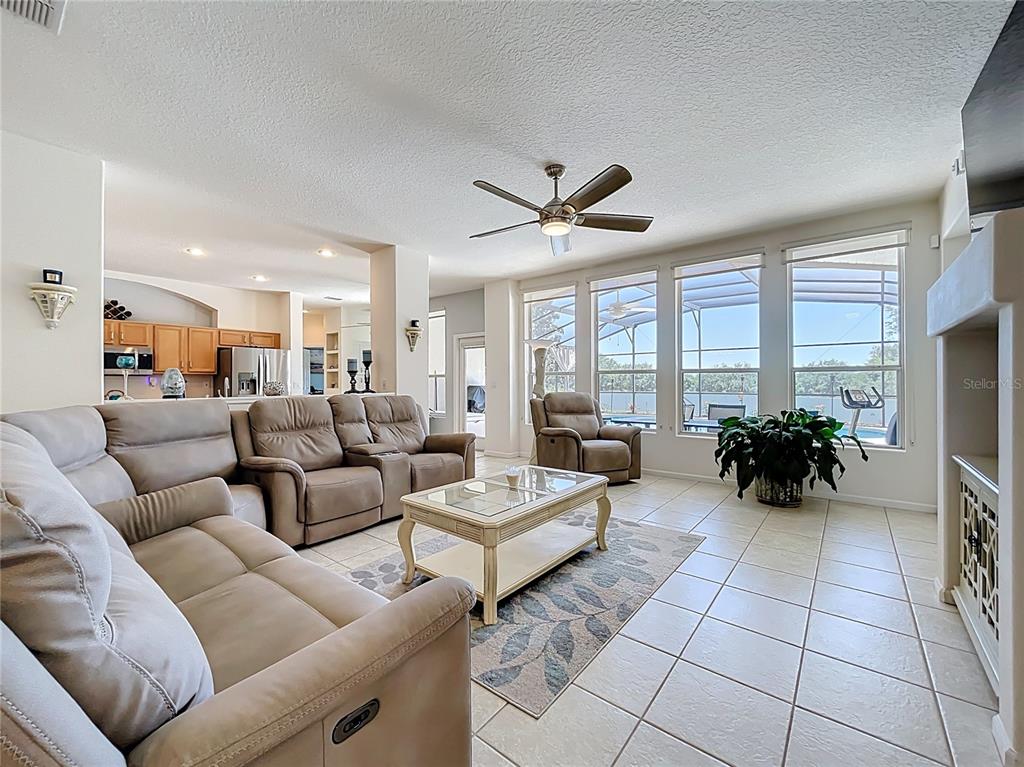 13319 Via Roma Circle Clermont, FL 34711 - Photo 6 of 44 a living room with furniture and a large window