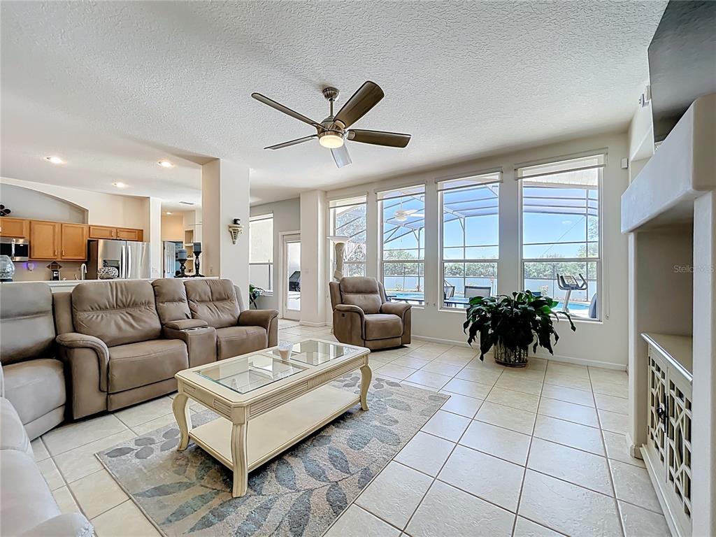 13319 Via Roma Circle Clermont, FL 34711 - Photo 8 of 44 a living room with furniture and a flat screen tv