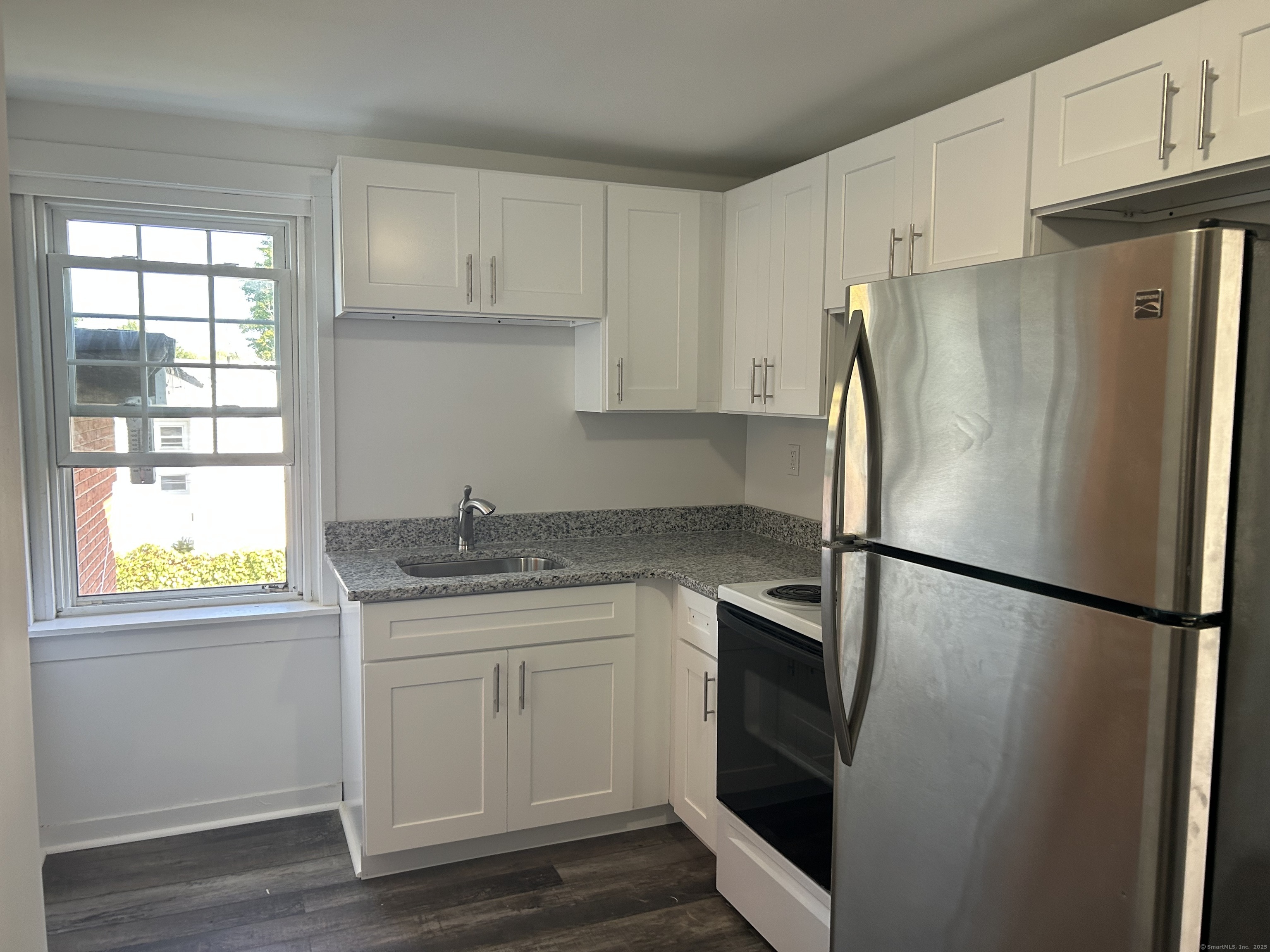 121 Pleasant Street Windsor, CT 06095 - Photo 1 of 8 a kitchen with stainless steel appliances a refrigerator sink and cabinets