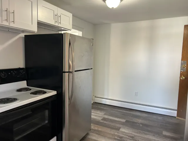 a kitchen with a refrigerator and cabinets
