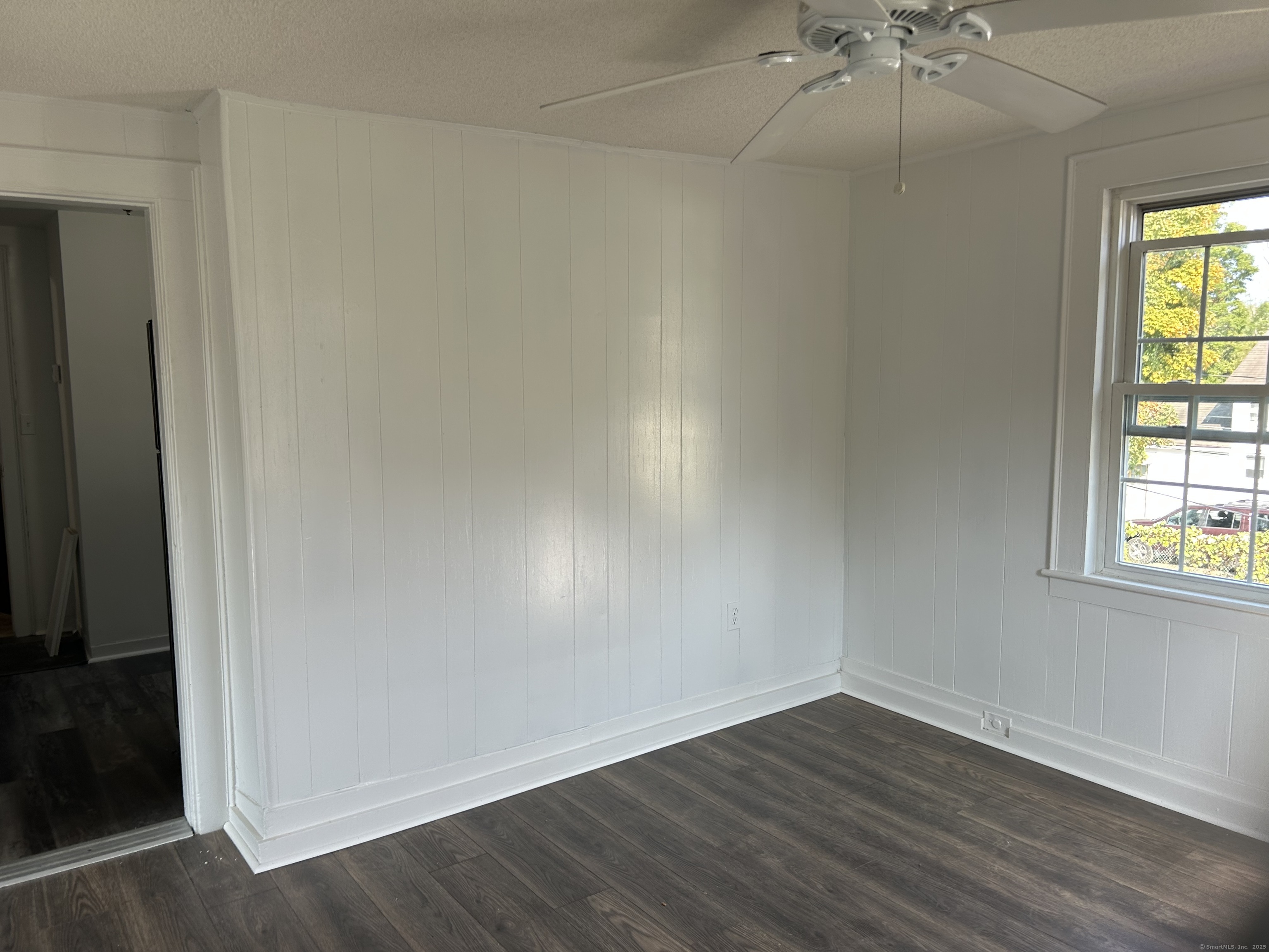 121 Pleasant Street Windsor, CT 06095 - Photo 5 of 8 an empty room with a window and wooden floor