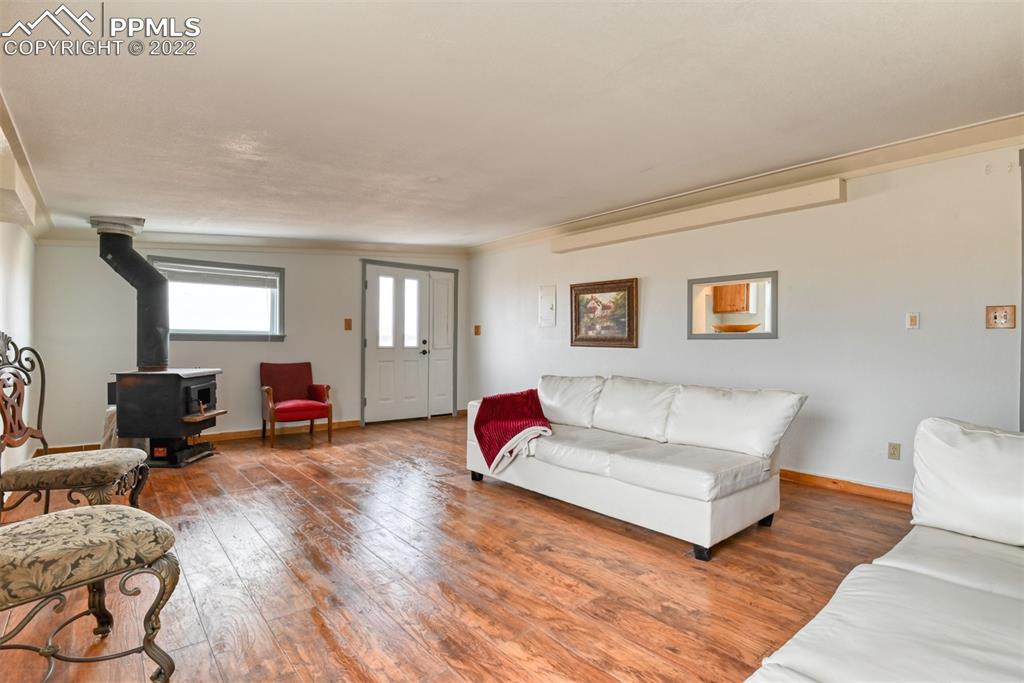 6175 Mulberry Road Calhan, CO 80808 - Photo 13 of 46 a living room with furniture and a wooden floor