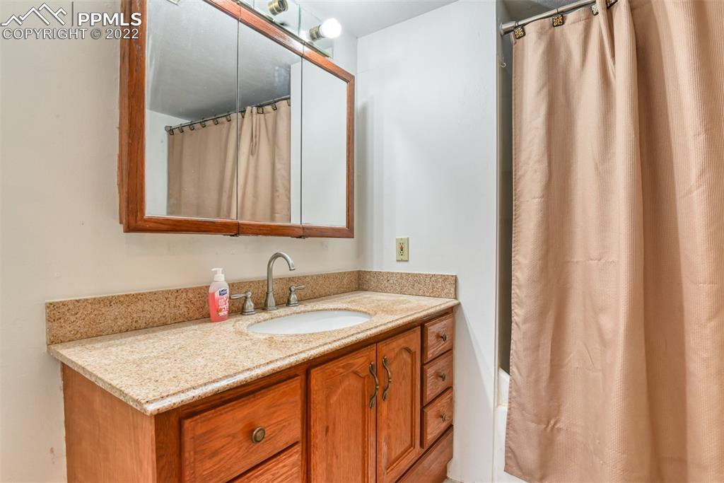 6175 Mulberry Road Calhan, CO 80808 - Photo 25 of 46 a bathroom with a sink and a mirror