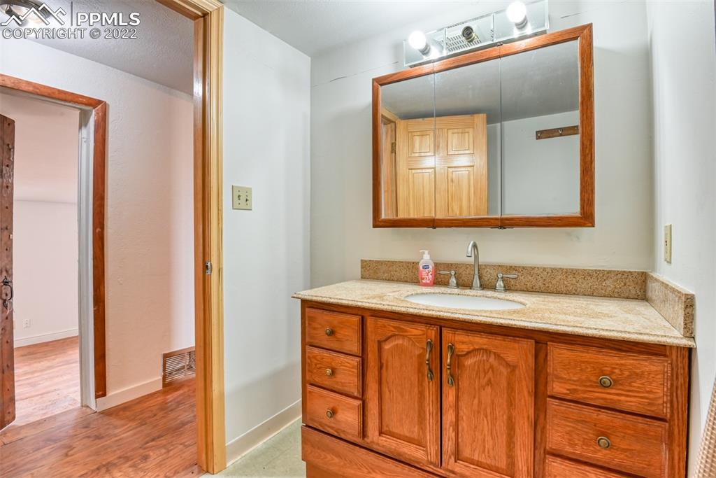 6175 Mulberry Road Calhan, CO 80808 - Photo 26 of 46 a bathroom with a sink and a mirror