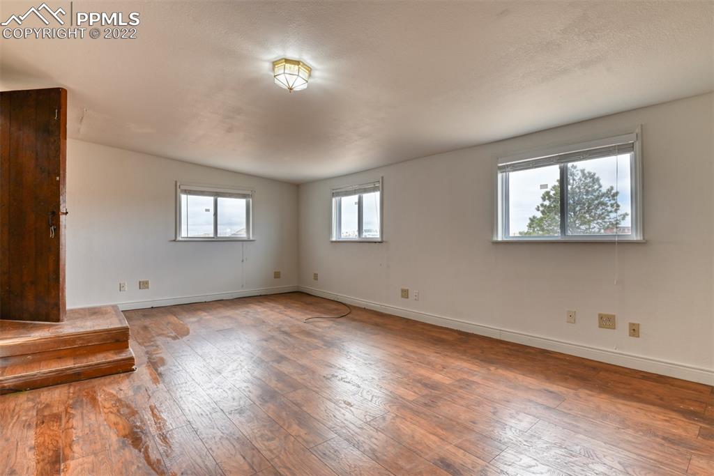 6175 Mulberry Road Calhan, CO 80808 - Photo 28 of 46 a view of an empty room with wooden floor and a window
