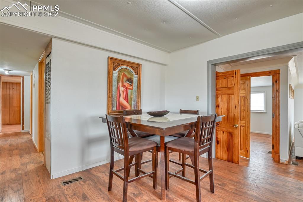6175 Mulberry Road Calhan, CO 80808 - Photo 35 of 46 a view of a dining room with furniture window and wooden floor