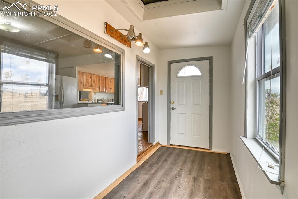 6175 Mulberry Road Calhan, CO 80808 - Photo 41 of 46 a view of an empty room with wooden floor and a window
