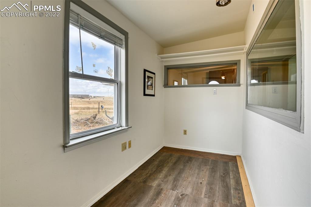 6175 Mulberry Road Calhan, CO 80808 - Photo 42 of 46 a view of empty room with window and wooden floor