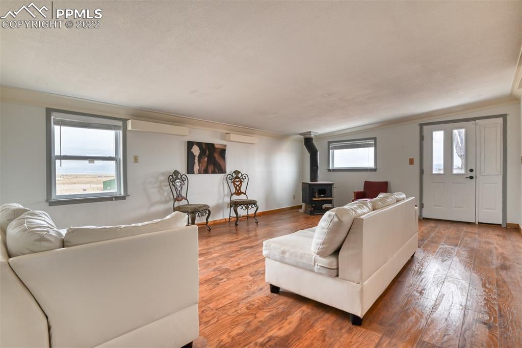 6175 Mulberry Road Calhan, CO 80808 - Photo 10 of 46 a living room with furniture and a wooden floor