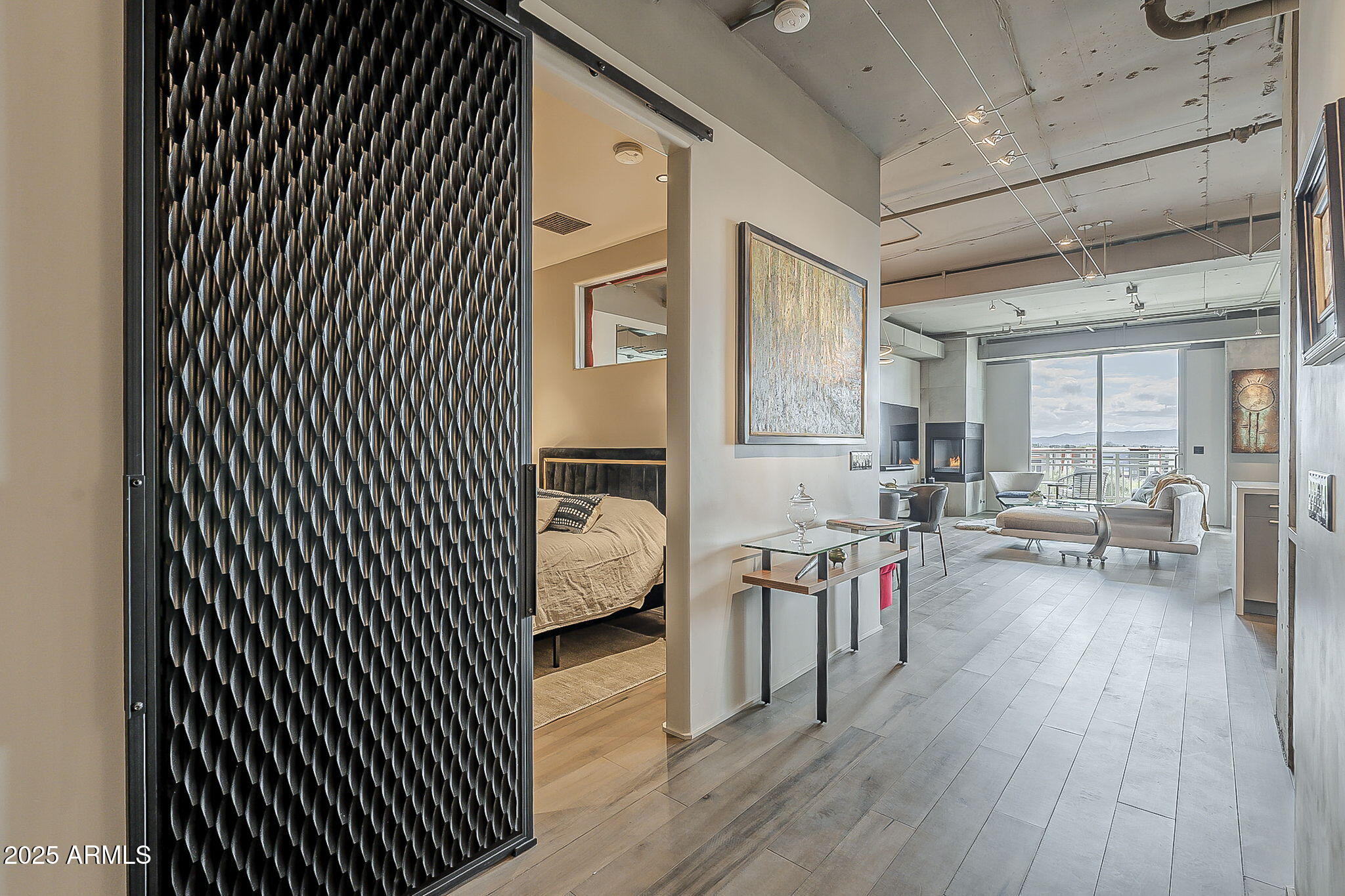 2211 East Camelback Road, Unit 605 Phoenix, AZ 85016 - Photo 12 of 56 a living room with furniture and a wooden floor