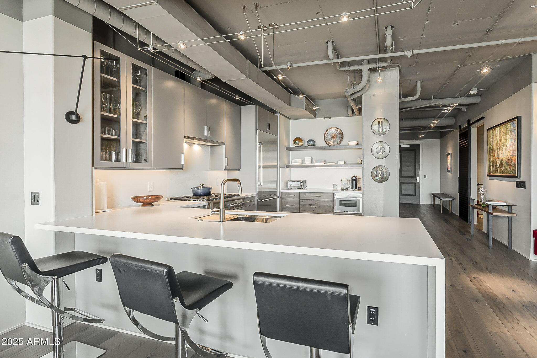 2211 East Camelback Road, Unit 605 Phoenix, AZ 85016 - Photo 24 of 56 a kitchen with a table chairs refrigerator and cabinets