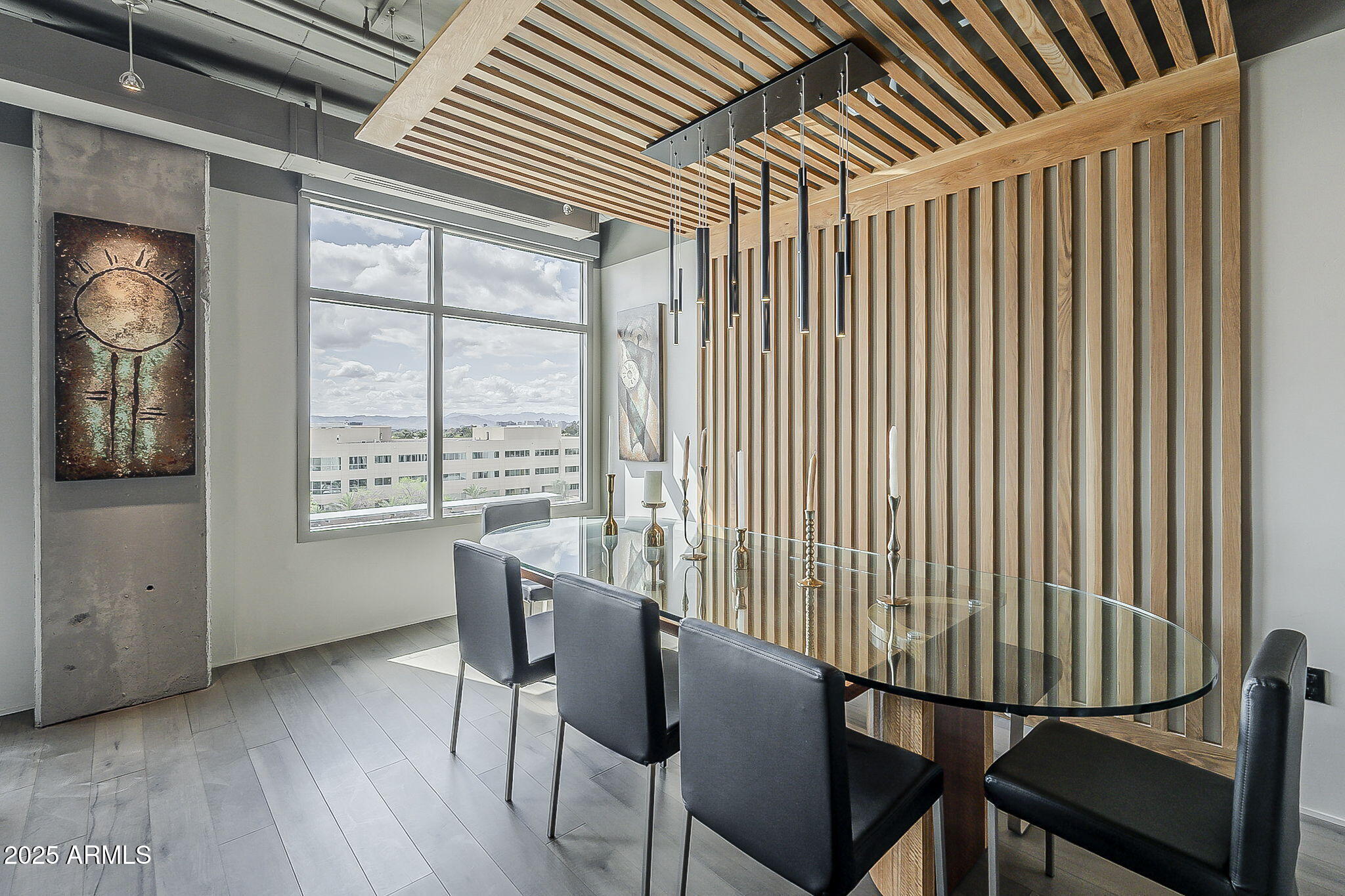 2211 East Camelback Road, Unit 605 Phoenix, AZ 85016 - Photo 25 of 56 a view of a dining room with furniture window and wooden floor