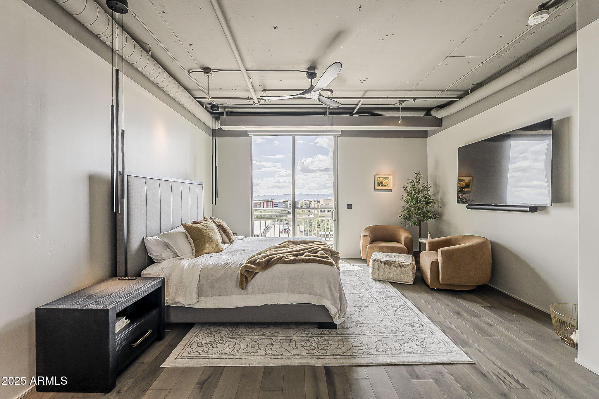 2211 East Camelback Road, Unit 605 Phoenix, AZ 85016 - Photo 32 of 56 a spacious bedroom with a bed couch and a window