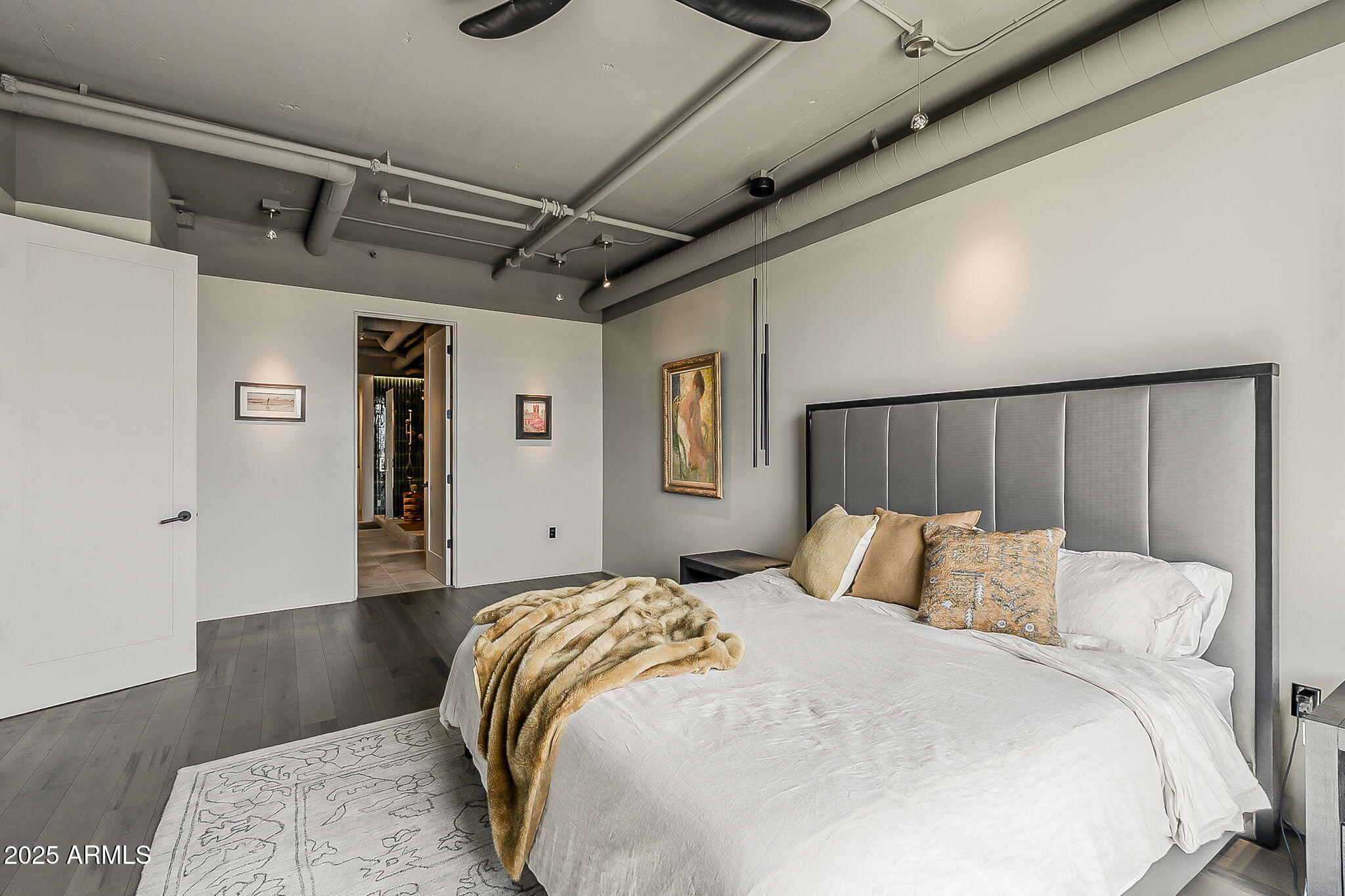 2211 East Camelback Road, Unit 605 Phoenix, AZ 85016 - Photo 33 of 56 a bedroom with a bed and wooden floor