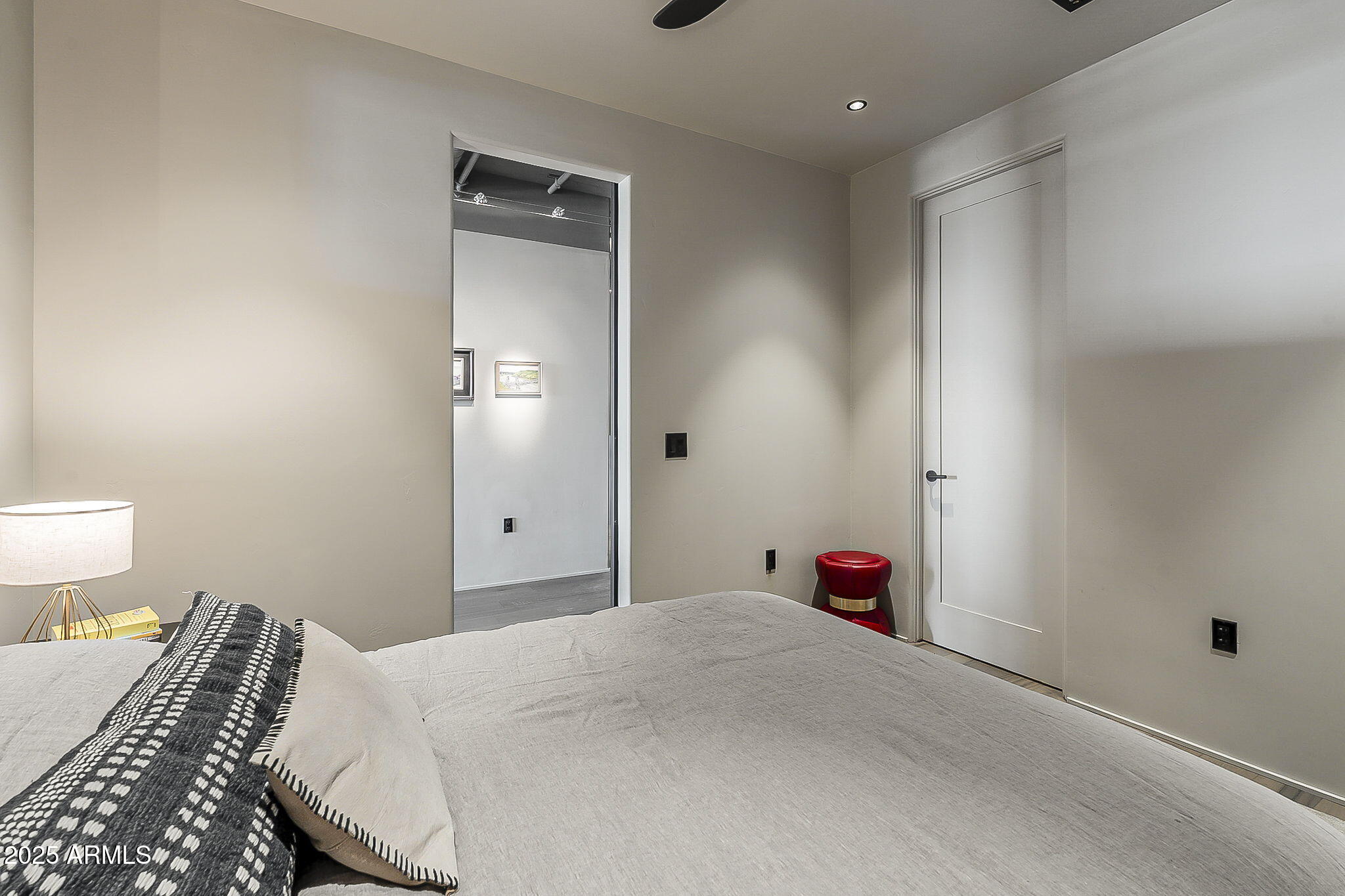 2211 East Camelback Road, Unit 605 Phoenix, AZ 85016 - Photo 44 of 56 a bedroom with a bed and a lamp