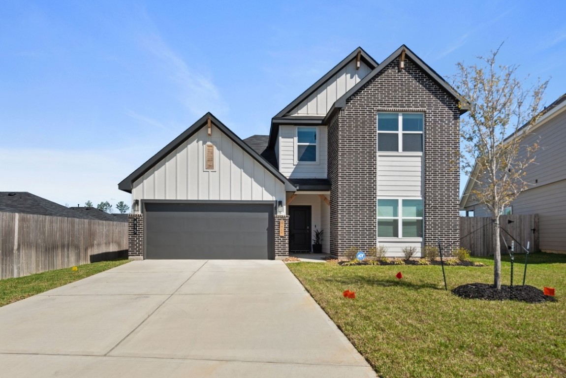 815 Devils Bridge Street Conroe, TX 77303 - Photo 1 of 25 a front view of a house with a yard and porch