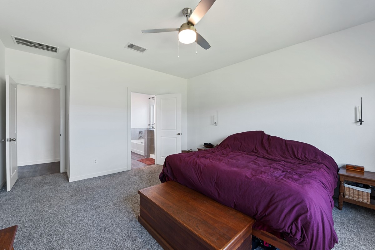 815 Devils Bridge Street Conroe, TX 77303 - Photo 11 of 25 a living room with a bed and a chandelier