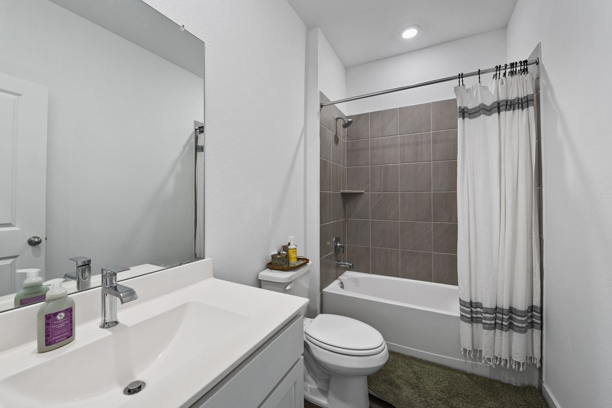 815 Devils Bridge Street Conroe, TX 77303 - Photo 15 of 25 a bathroom with a sink toilet and shower