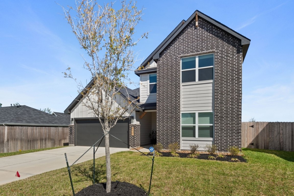 815 Devils Bridge Street Conroe, TX 77303 - Photo 2 of 25 a view of a house with a yard