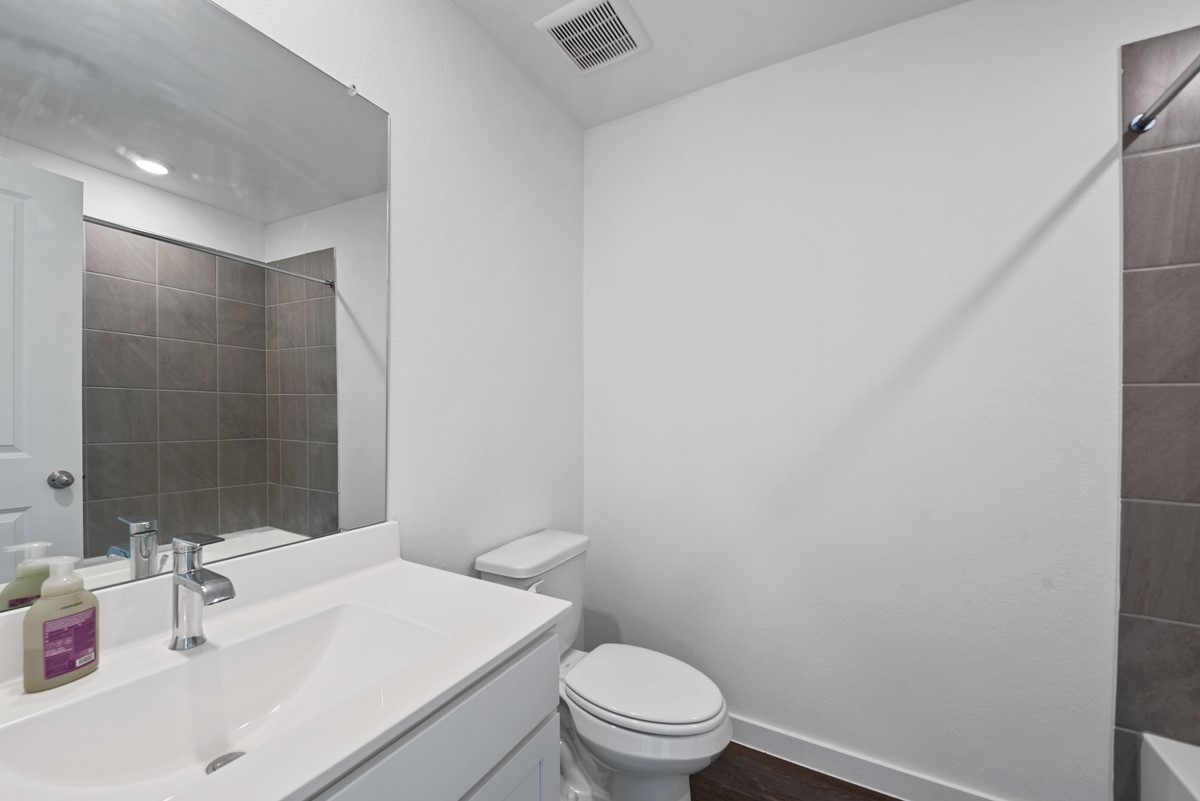 815 Devils Bridge Street Conroe, TX 77303 - Photo 21 of 25 a bathroom with a sink a toilet and shower
