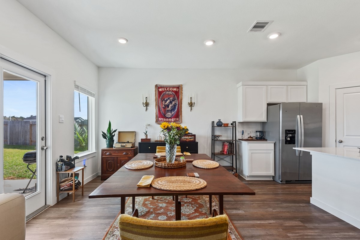815 Devils Bridge Street Conroe, TX 77303 - Photo 6 of 25 a view of a dining room with furniture a kitchen and chandelier