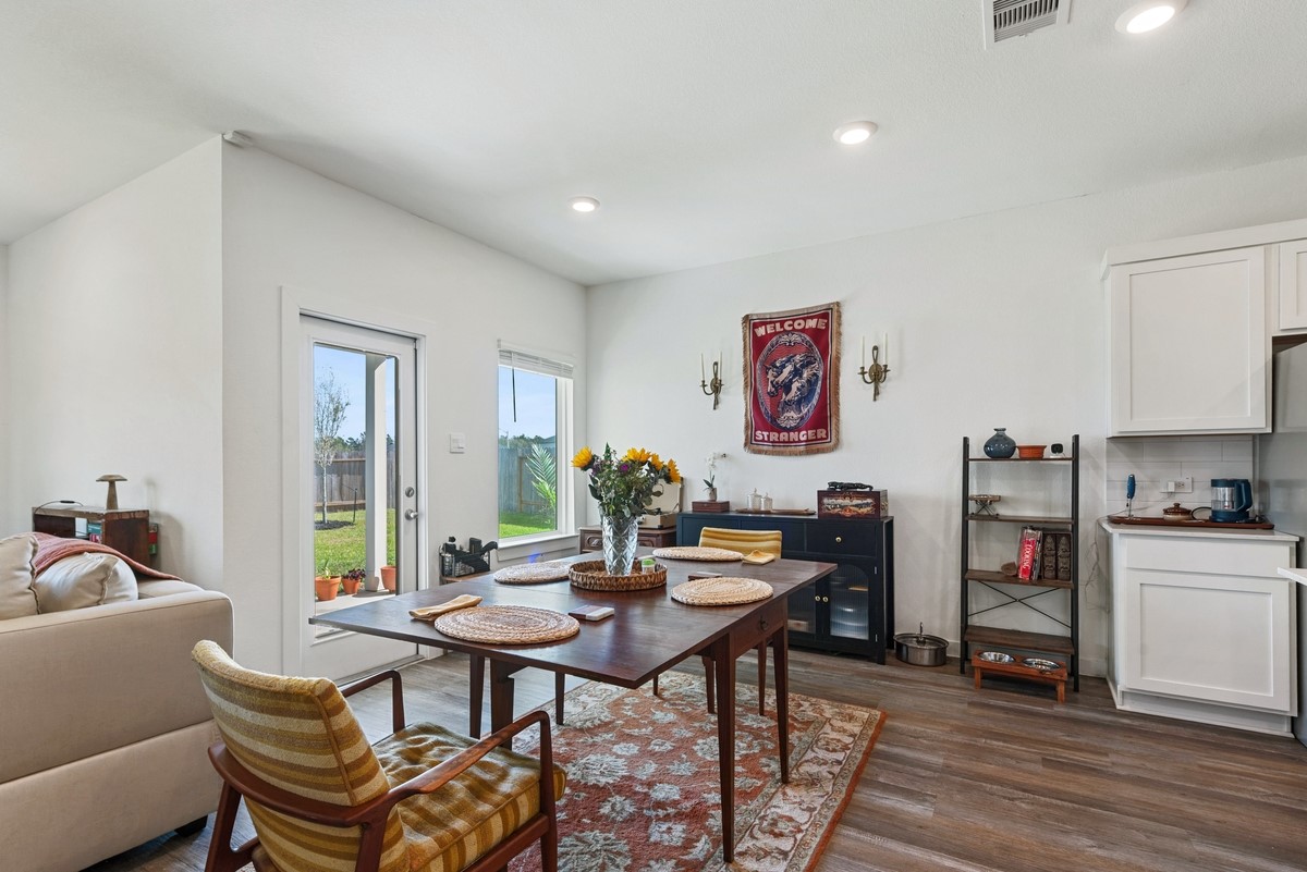 815 Devils Bridge Street Conroe, TX 77303 - Photo 7 of 25 a view of a dining room with furniture and wooden floor