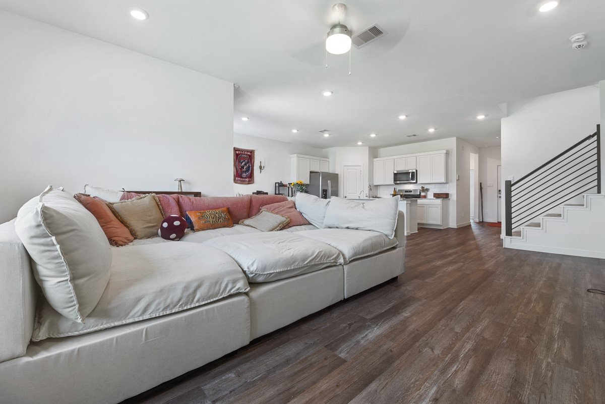 815 Devils Bridge Street Conroe, TX 77303 - Photo 9 of 25 a large bedroom with a bed and a couch