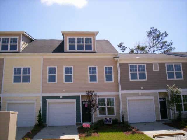 145 Deacon Ridge Street Wake Forest, NC 27587 - Photo 1 of 9 a front view of a house with yard and garage