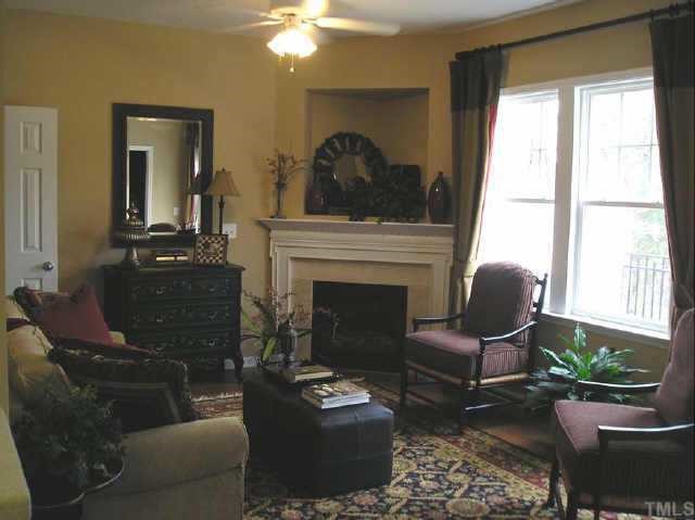 145 Deacon Ridge Street Wake Forest, NC 27587 - Photo 6 of 9 a living room with furniture and a fireplace