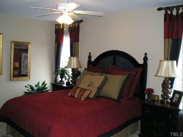145 Deacon Ridge Street Wake Forest, NC 27587 - Photo 7 of 9 a bedroom with a bed window and a ceiling fan