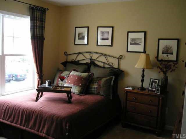 145 Deacon Ridge Street Wake Forest, NC 27587 - Photo 8 of 9 a bedroom with a bed and wooden floor