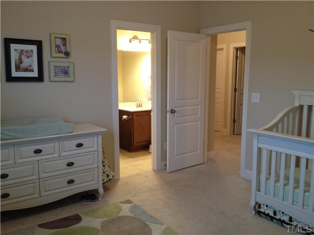 3614 Silver Forrest Lane Raleigh, NC 27614 - Photo 19 of 25 Bedroom 2 is located at the back of the home with double windows and a walk-in closet. This bedroom has a private, en-suite bath with tile floor and a tub with tile surrounds. Bedroom