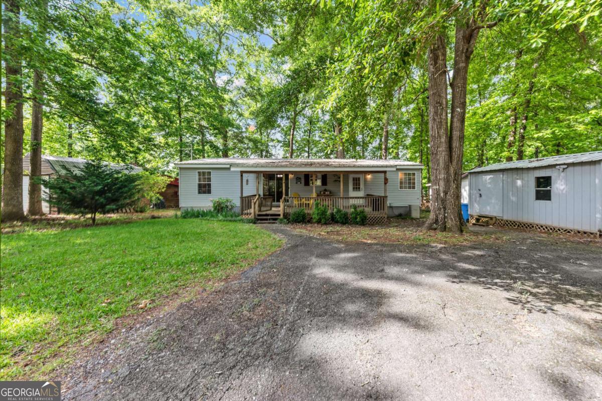 194 Phillips Road Eatonton, GA 31024 - Photo 36 of 57 a view of a house with backyard and sitting area