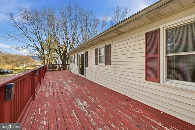a view of backyard with a deck and wooden floor
