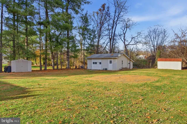 a house view with swimming pool in front of it