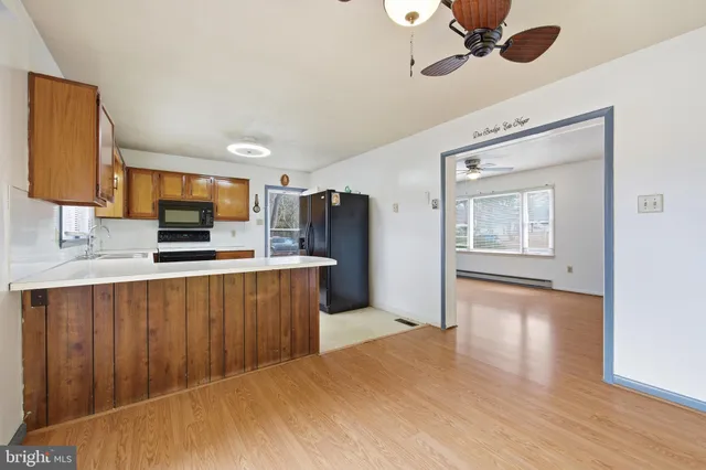 a kitchen with stainless steel appliances a refrigerator sink and cabinets