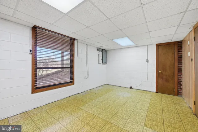 a view of a kitchen with refrigerator and a sink