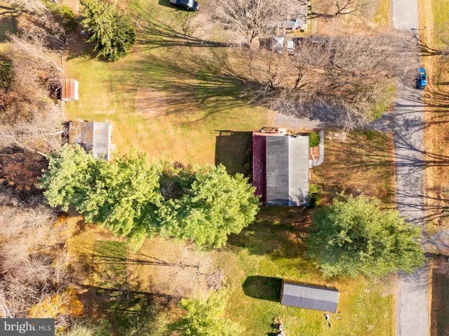 a yellow building with trees in front of it