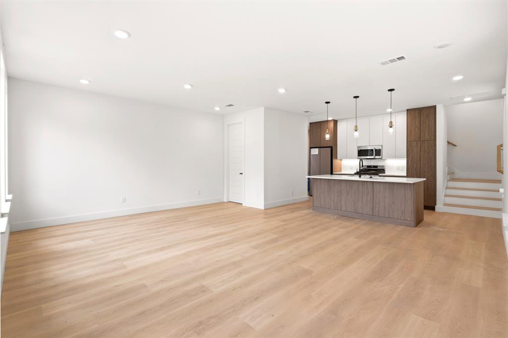 413 North Patton Avenue Dallas, TX 75203 - Photo 7 of 21 a view of a kitchen with kitchen island a sink stainless steel appliances and cabinets