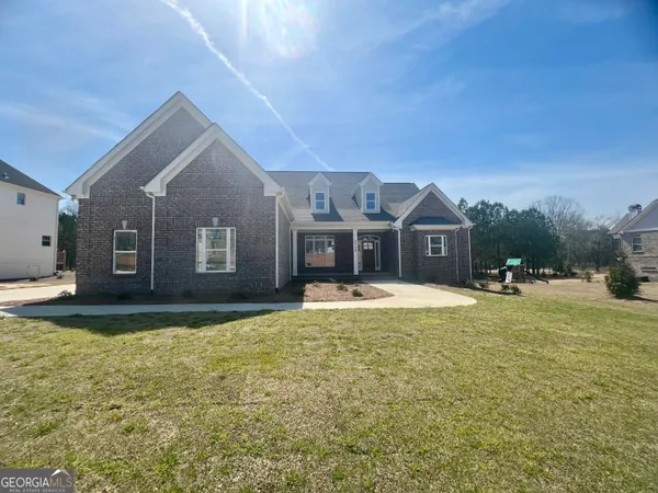 a view of a house with swimming pool and a yard
