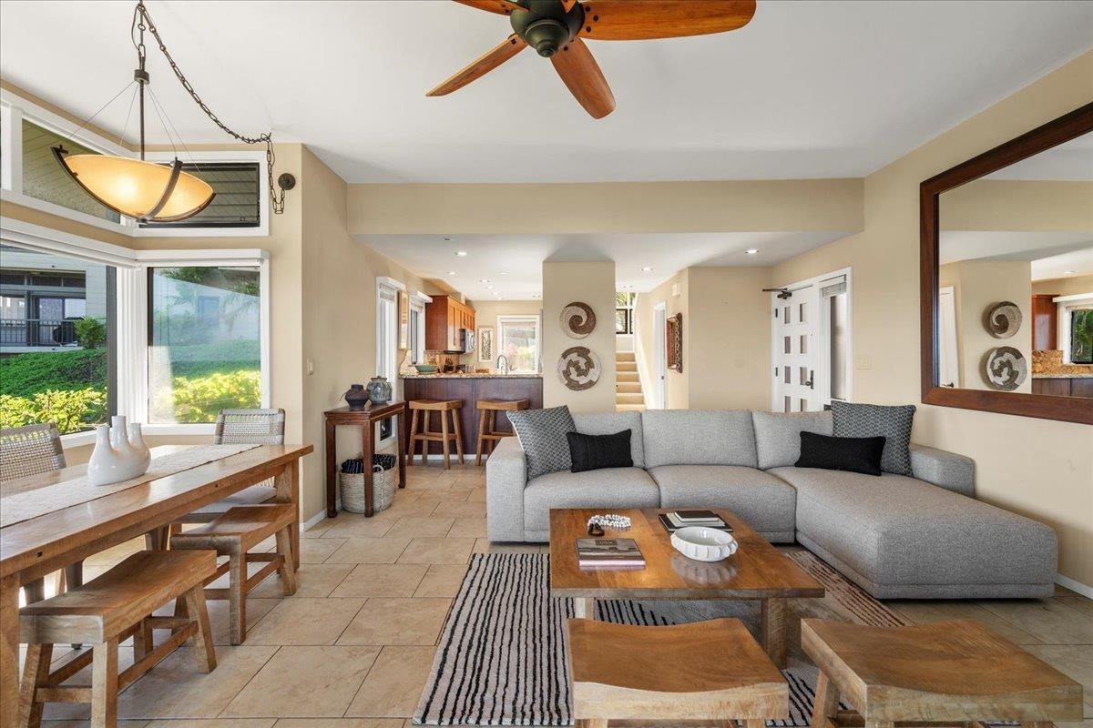 100 Ridge Road, Unit 2915 Lahaina, HI 96761 - Photo 2 of 43 a living room with furniture a dining table and a floor to ceiling window