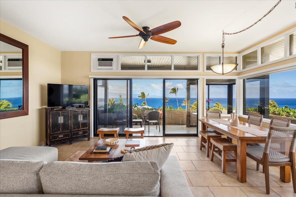 100 Ridge Road, Unit 2915 Lahaina, HI 96761 - Photo 9 of 43 a living room with furniture a flat screen tv and a large window