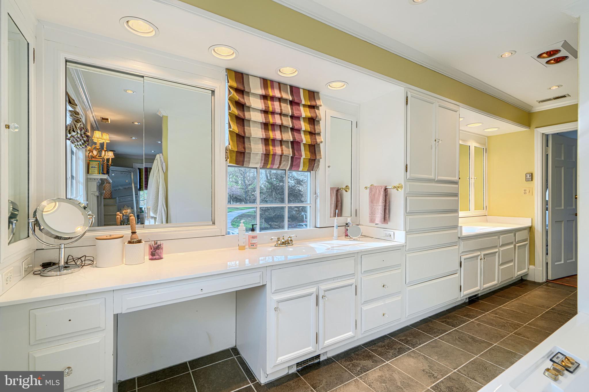 227 Greenspring Valley Road Owings Mills, MD 21117 - Photo 55 of 85 a bathroom with a sink double vanity and a mirror