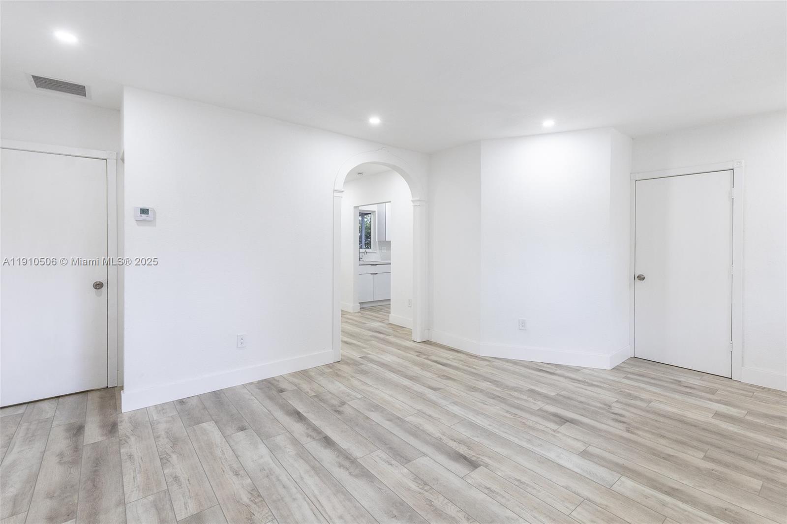 6440 Southwest 20th Street Miramar, FL 33023 - Photo 17 of 31 an empty room with wooden floor and windows