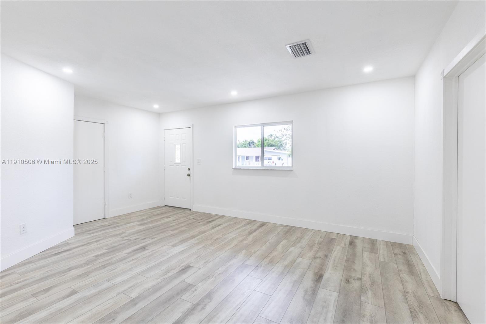 6440 Southwest 20th Street Miramar, FL 33023 - Photo 18 of 31 an empty room with wooden floor and windows