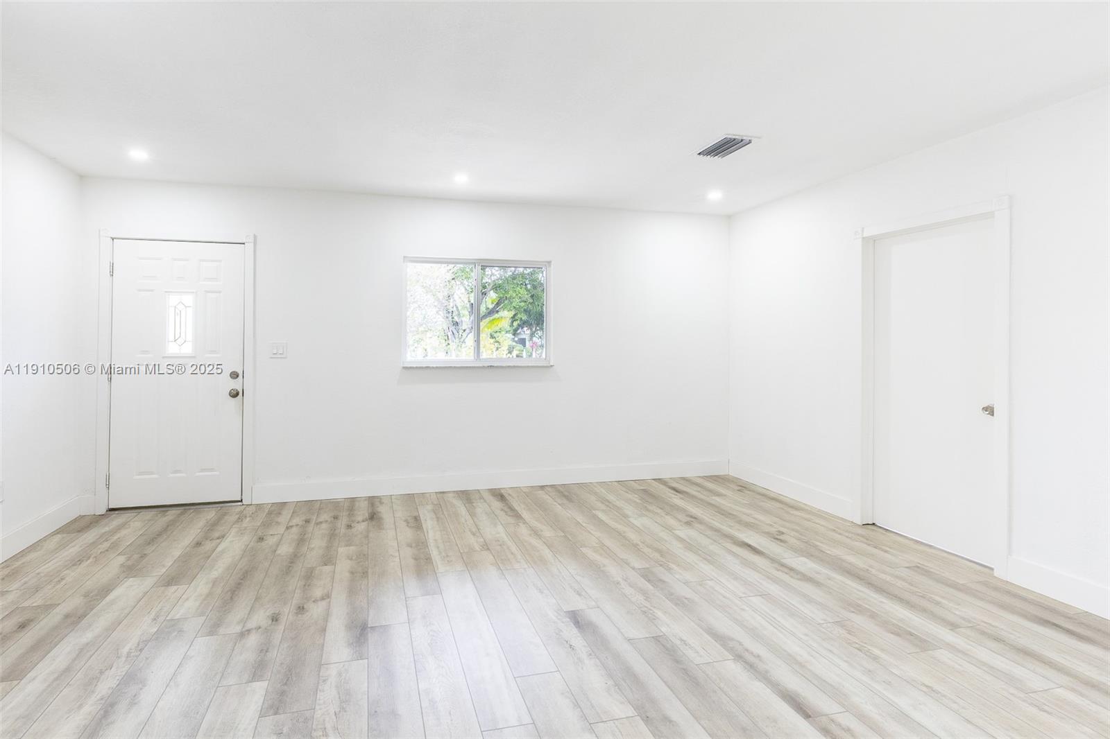 6440 Southwest 20th Street Miramar, FL 33023 - Photo 19 of 31 an empty room with wooden floor and window