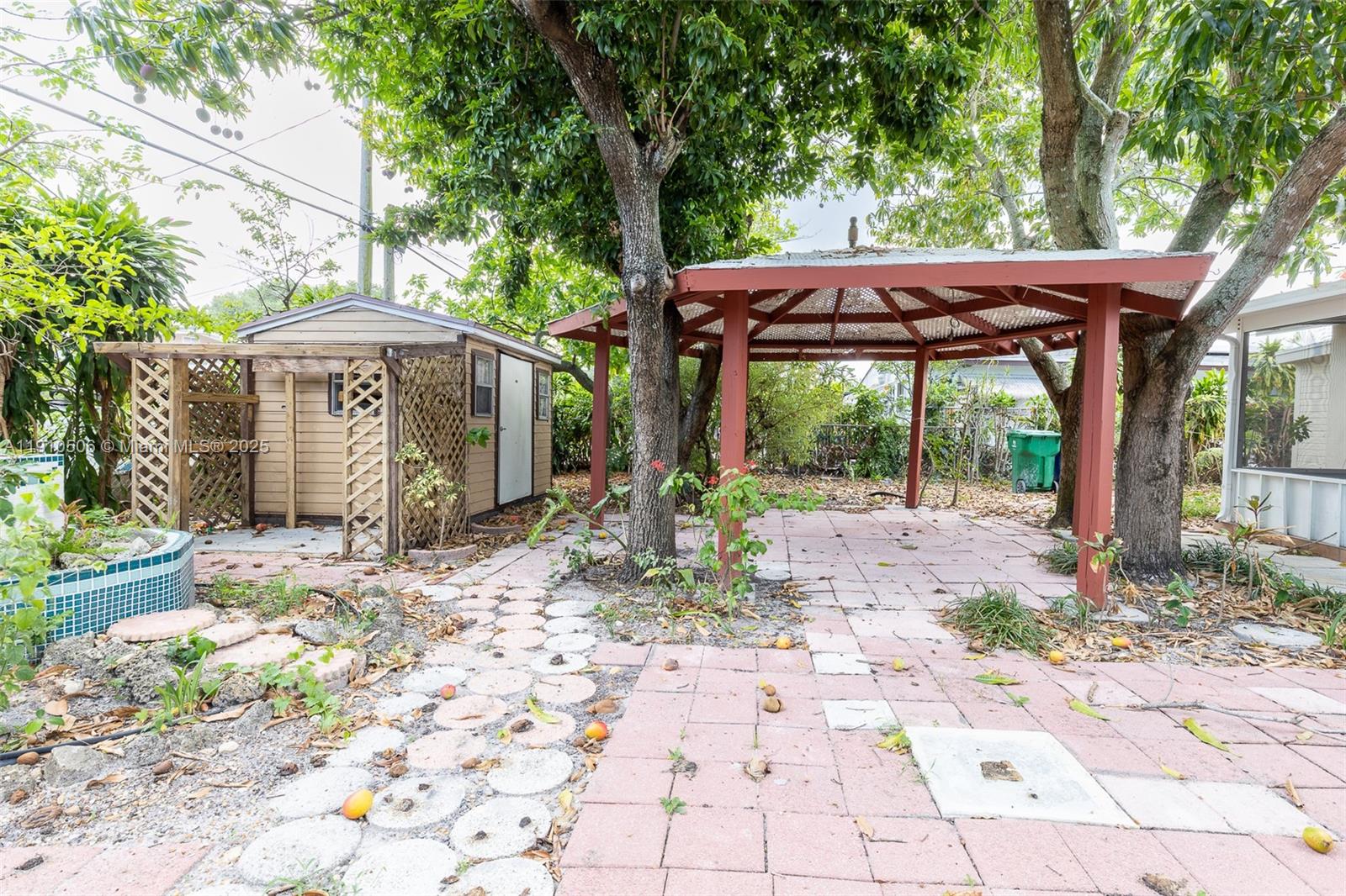 6440 Southwest 20th Street Miramar, FL 33023 - Photo 26 of 31 a view of a small yard with plants and large trees