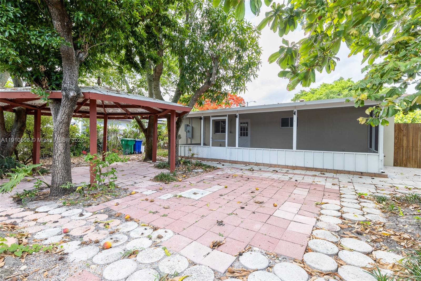6440 Southwest 20th Street Miramar, FL 33023 - Photo 27 of 31 a backyard of a house with large trees and outdoor seating